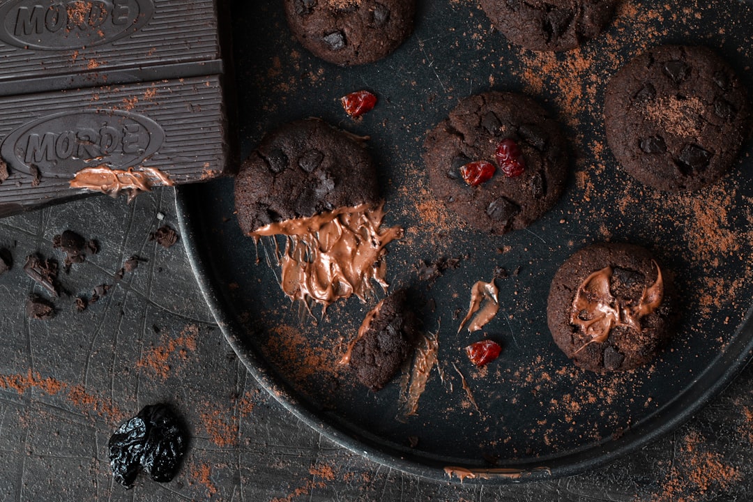 a plate of chocolate cookies with a bite taken out of one