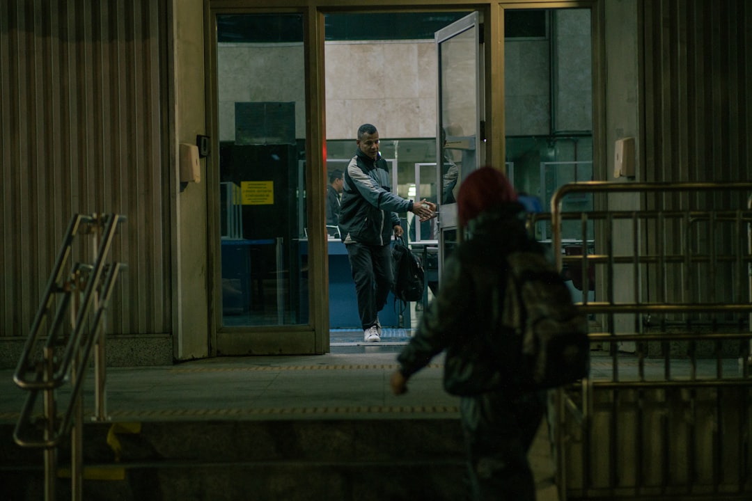 A man walking out of a building at night