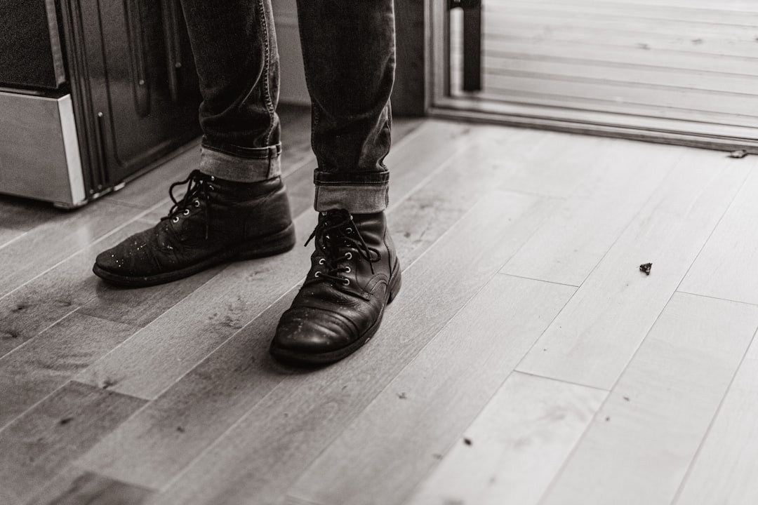 A person standing on a hard wood floor