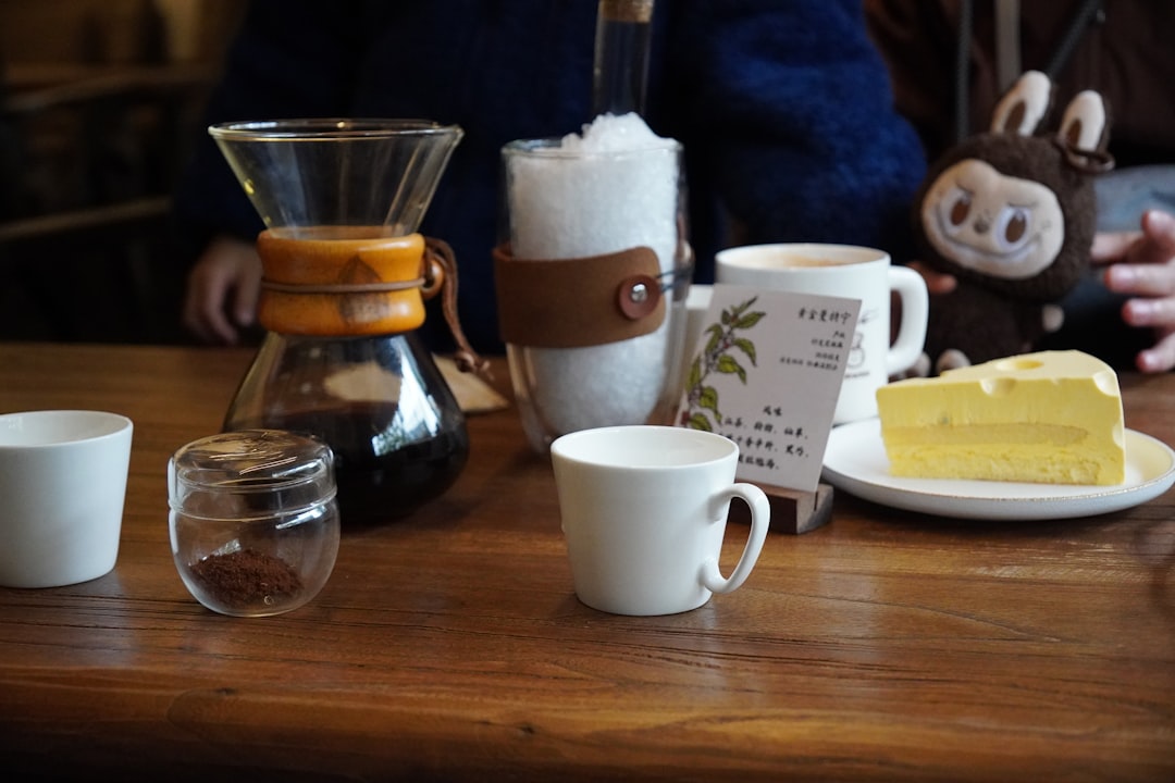 Coffee, dessert, and drinks are arranged on a table.