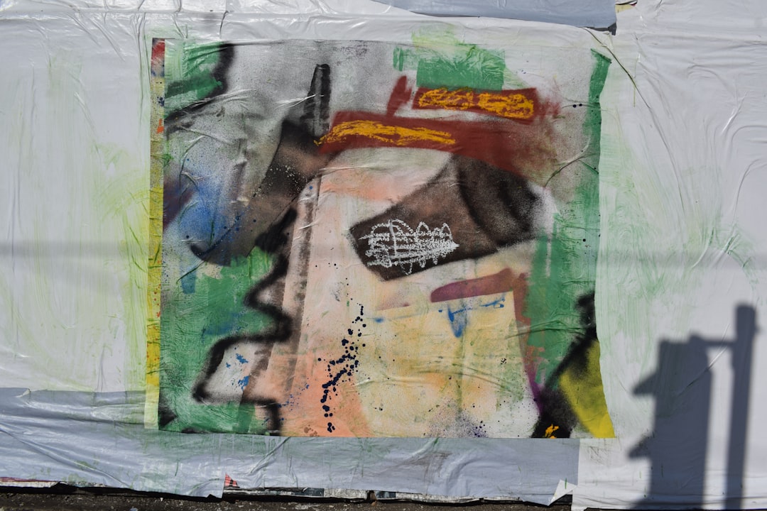 A picture of a person standing in front of a wall covered in graffiti